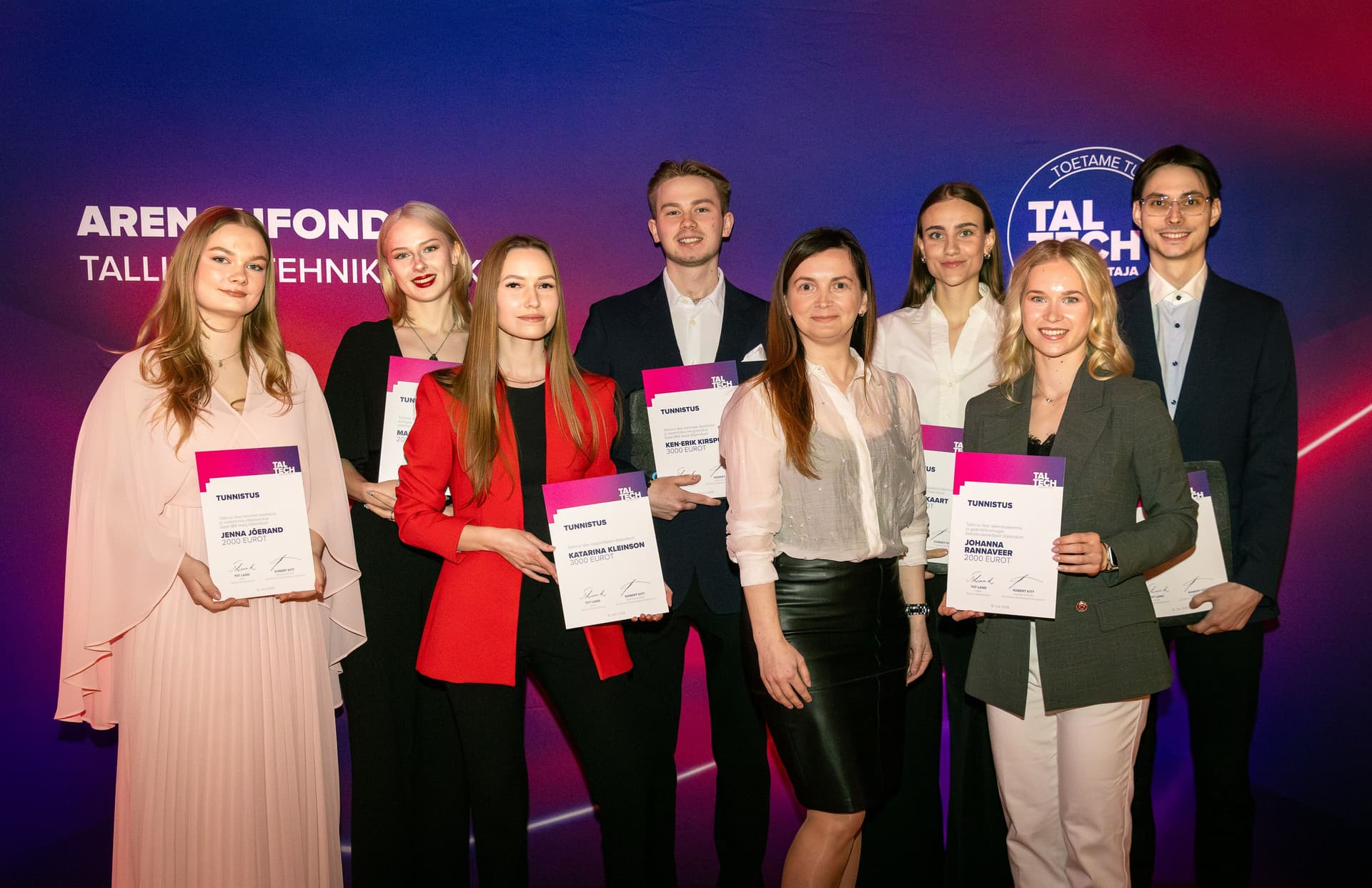 Eight formally dressed young adults proudly display certificates at a Tallinn Tech awards event.